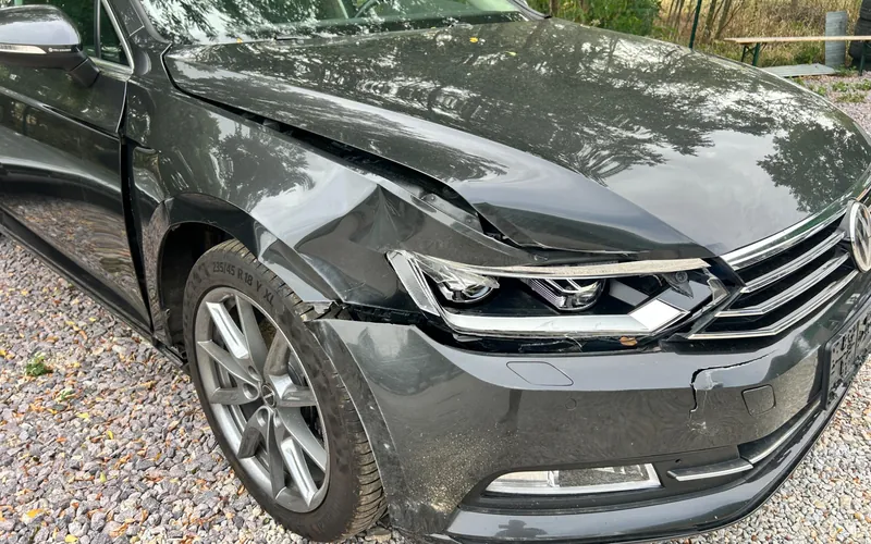 Poškodený predok Volkswagenu Passat po zrážke so zverou — nárazník, svetlomet, blatník a kapota